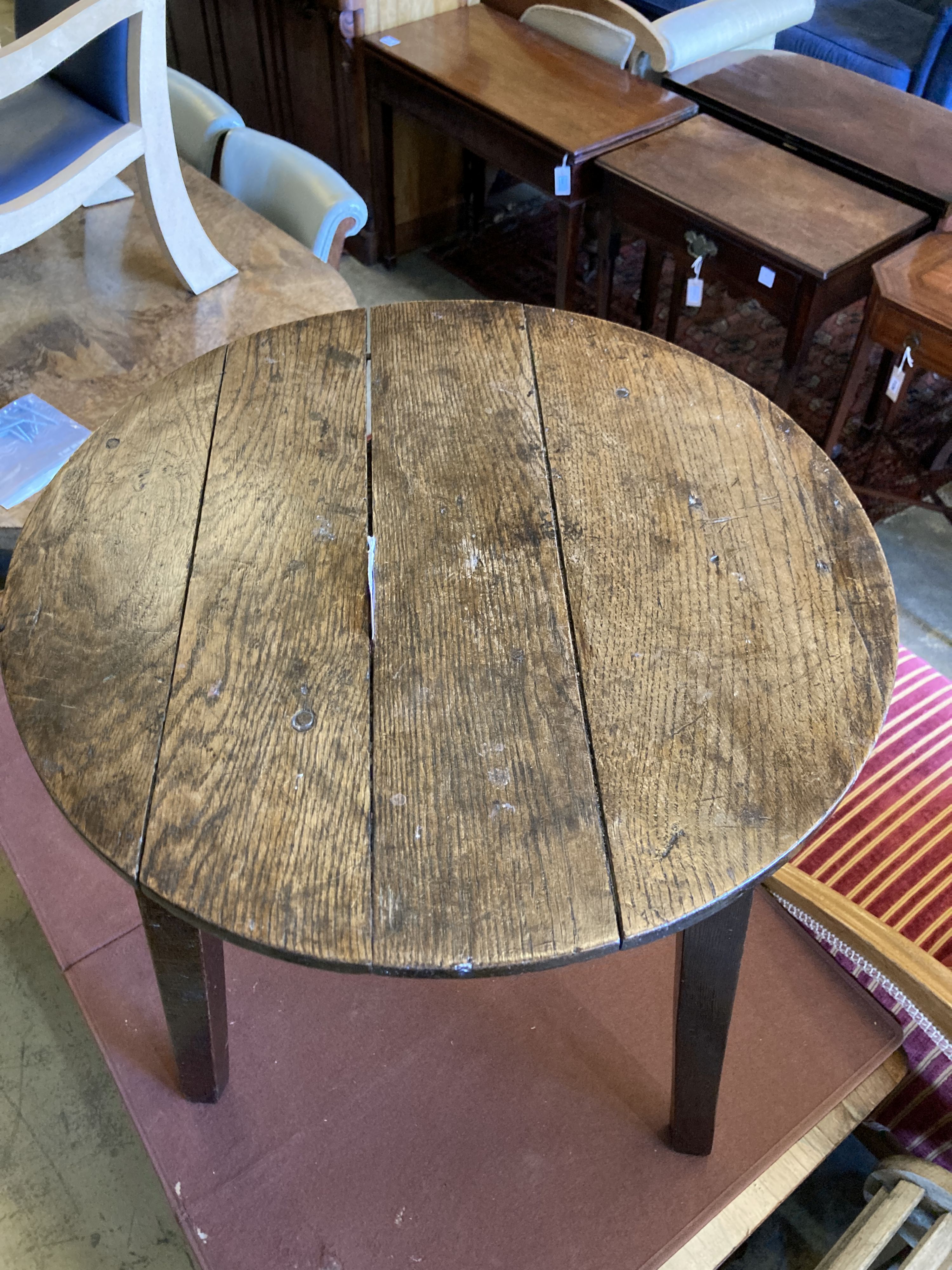 A 19th century circular oak cricket table, 55cm diameter, height 69cm